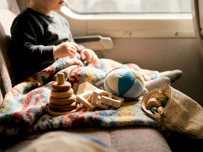 Lap rug with Montessori toddler travel toys arranged