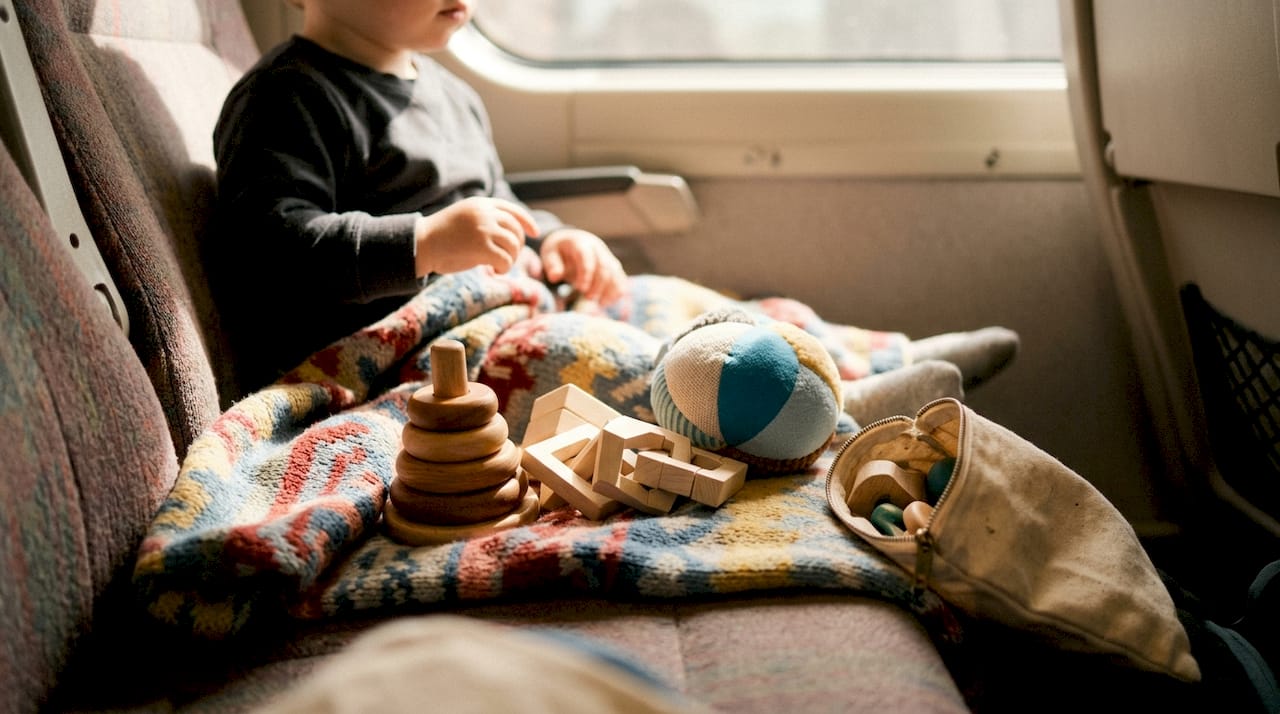 Lap rug with Montessori toddler travel toys arranged