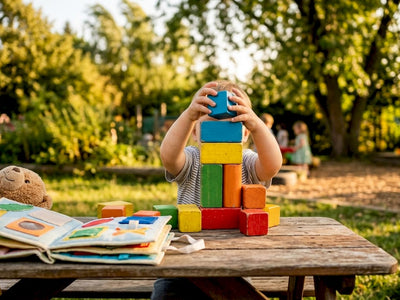 Toddler hands playing with wooden blocks