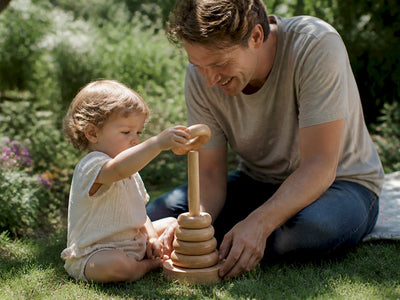 Parent handing child FSC certified wooden toy