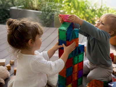 Children building stable magnet tile tower