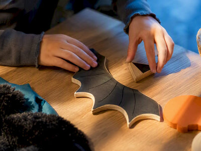 Child arranging gentle spooky play materials