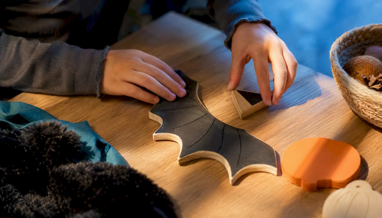 Child arranging gentle spooky play materials