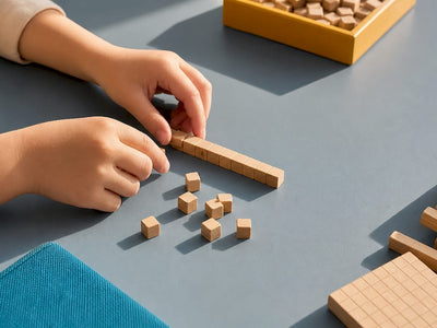 Hands grouping anonymous base ten pieces