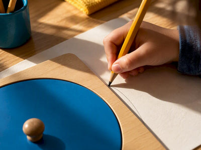 Child tracing a metal inset frame