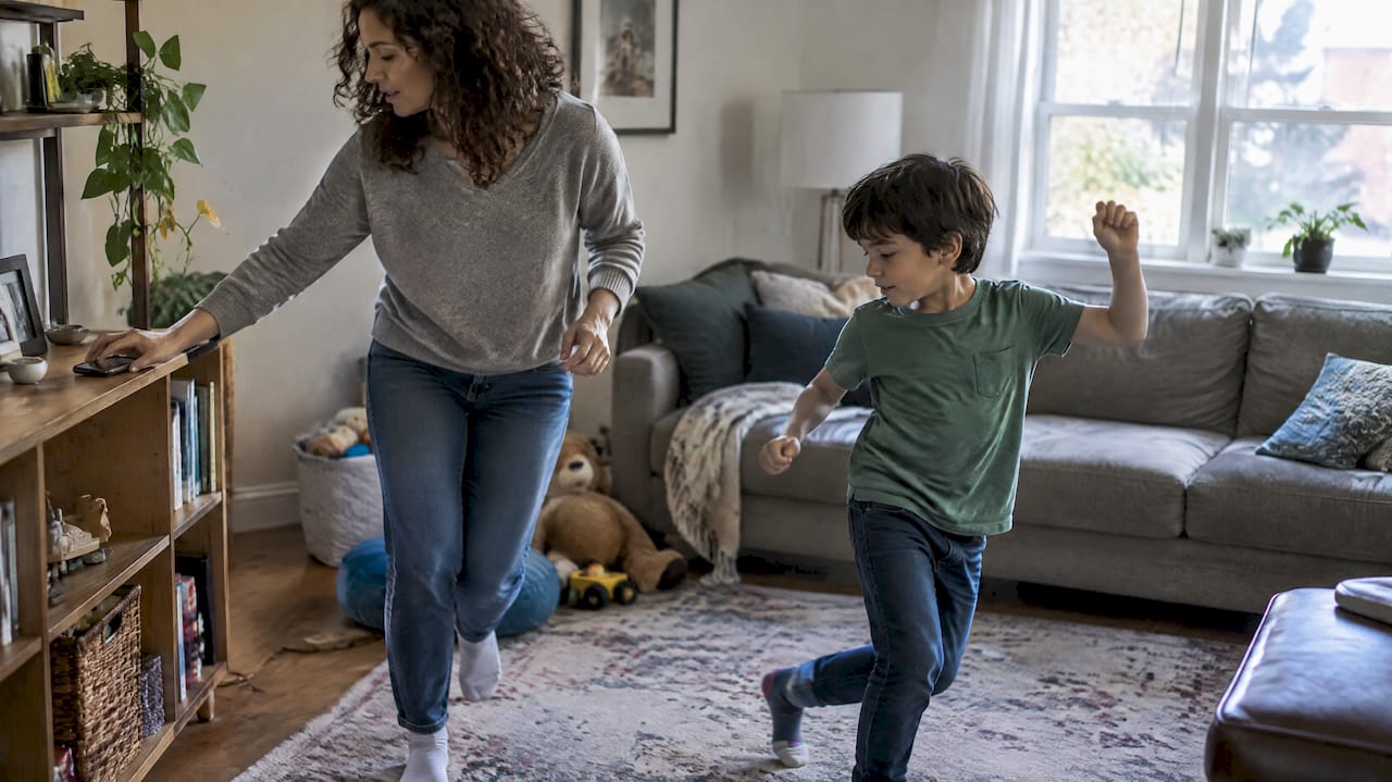 Parent and child starting a screen-free dance break
