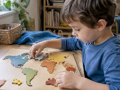 Child fitting a piece into a wooden map puzzle