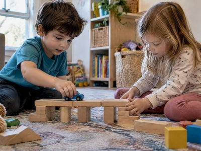 Children testing a block bridge with a toy car