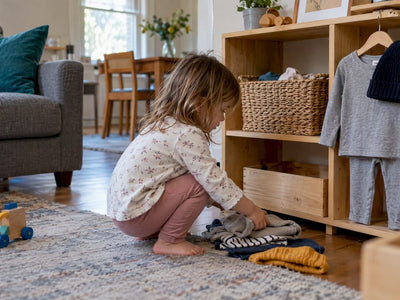 Toddler choosing a basket from a low shelf