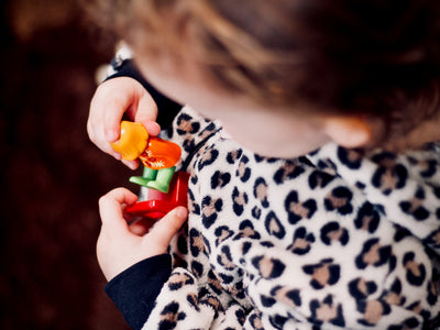 girl holding plastic toys in macro photography