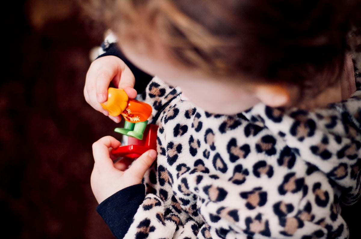 girl holding plastic toys in macro photography