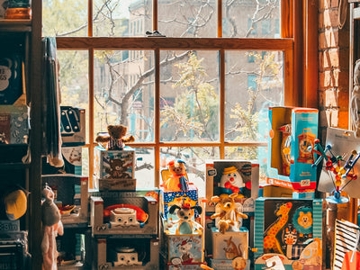 assorted plush toys on brown wooden shelf