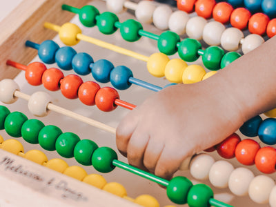 person holding red and blue abacus