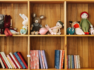assorted animal plush toys on brown wooden shelf