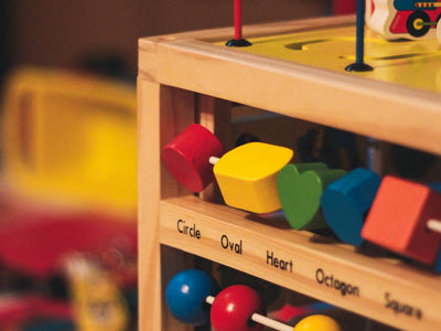 a wooden toy truck with lots of toys on top of it