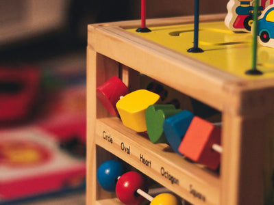 a wooden toy with lots of colorful toys on top of it