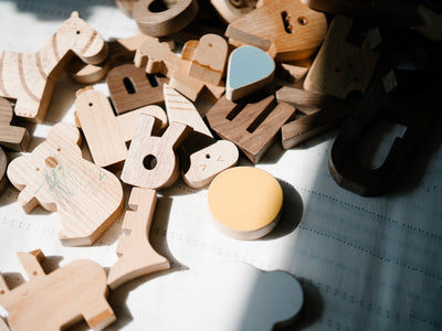 a pile of wooden toys sitting on top of a table