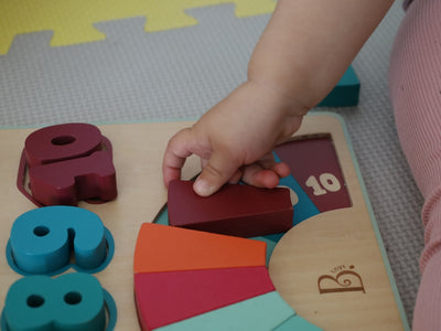 a child is playing with wooden toys on the floor