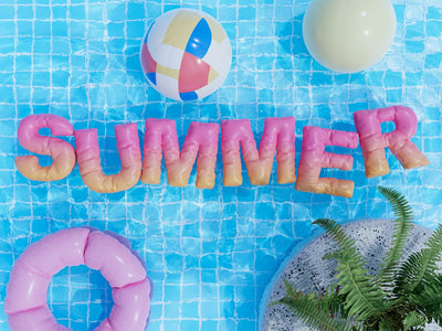 a pool with a pool float, inflatable toys, and the word summer