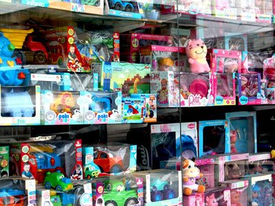 Toys are displayed inside of a store window.