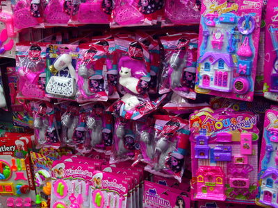 Pink toys and accessories are displayed for sale.