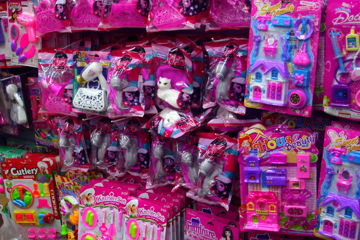 Pink toys and accessories are displayed for sale.