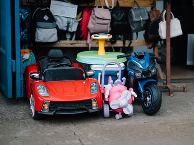 Children's ride-on toys and backpacks displayed bags