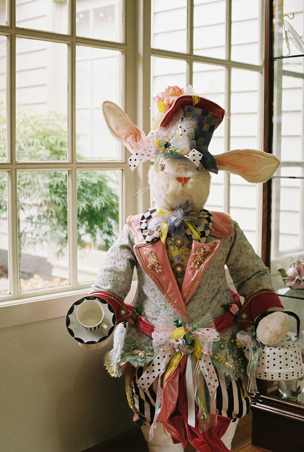 A whimsical easter bunny dressed in a colorful suit.