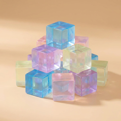 Mini ice cube squishies on a beige studio background