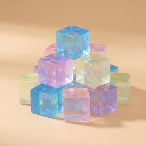 Mini ice cube squishies on a beige studio background