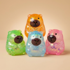 Capybara squishy toys on a beige studio background