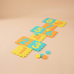 Yellow interlocking foam hopscotch mat with nine numbered tiles and three marker discs