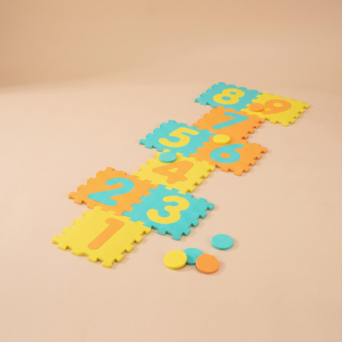 Yellow interlocking foam hopscotch mat with nine numbered tiles and three marker discs